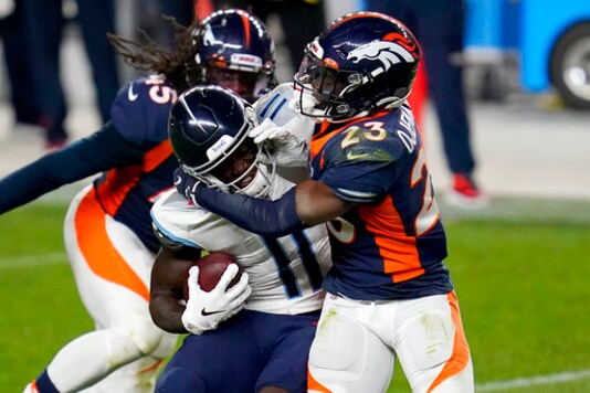 Tennessee Titans wide receiver A.J. Brown (11) is hit by Denver Broncos cornerback Michael Ojemudia (23) during the second half of an NFL football game, Monday, Sept. 14, 2020, in Denver. (AP Photo/David Zalubowski)