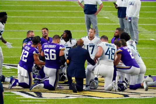 Tennessee Titans and the Minnesota Vikings players meet at midfield following an NFL football game, Sunday, Sept. 27, 2020, in Minneapolis. Tennessee won 31-30. The NFL says the Tennessee Titans and Minnesota Vikings are suspending in-person activities after the Titans had three players test positive for the coronavirus, along with five other personnel. The league says both clubs are working closely with the NFL and the players union on tracing contacts, more testing and monitoring developments. The Titans are scheduled to host the Pittsburgh Steelers on Sunday.(AP Photo/Jim Mone)