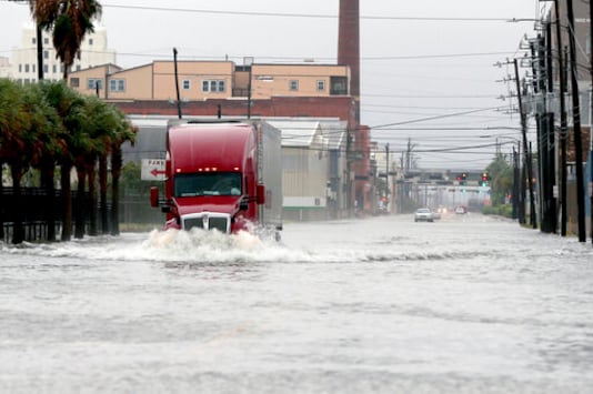 A truck drives through a flooded street in Galveston, Texas on Monday, Sept. 21, 2020. Parts of Texas and Louisiana braced for more flooding and damaging storm surge as Tropical Storm Beta slowly worked its way into a part of the country thats already been drenched and battered during this years exceptionally busy hurricane season. (Jennifer Reynolds/The Galveston County Daily News via AP)