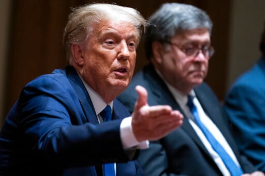 Attorney General William Barr listens as President Donald Trump speaks during a meeting with Republican state attorneys general about social media companies, in the Cabinet Room of the White House, Wednesday, Sept. 23, 2020, in Washington. (AP Photo/Evan Vucci)