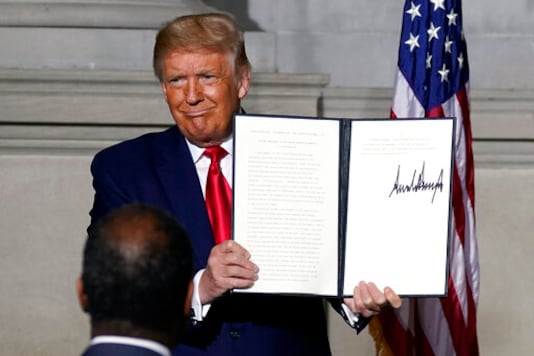 President Donald Trump holds a signed Constitution Day proclamation after he spoke to the White House conference on American History at the National Archives museum, Thursday, Sept. 17, 2020, in Washington. (AP Photo/Alex Brandon) President Donald Trump holds a signed Constitution Day proclamation after he spoke to the White House conference on American History at the National Archives museum, Thursday, Sept. 17, 2020, in Washington. (AP Photo/Alex Brandon)