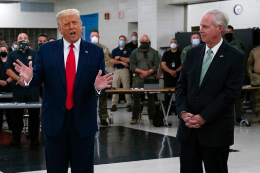 FILE - In this Sept. 1, 2020 file photo, President Donald Trump speaks in Kenosha, Wis., as Sen. Ron Johnson, R-Wis., right, listens. Sen. Johnson said Monday, Sept. 14, 2020, that President Donald Trump deserves to win more than one Nobel Peace Prize for his 