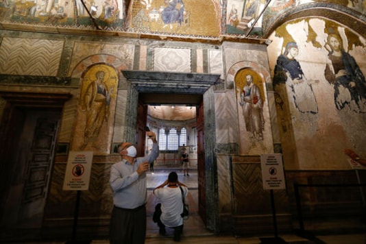 People visit St Savior in Chora church, known as Kariye in Turkish, in Istanbul, Friday, Aug. 21, 2020. Turkey on Friday formally converted former Byzantine church, St Savior in Chora, into a mosque, a month after it similarly turned Istanbul's landmark Hagia Sophia into a Muslim house of prayer, drawing international rebuke.(AP Photo/Emrah Gurel)