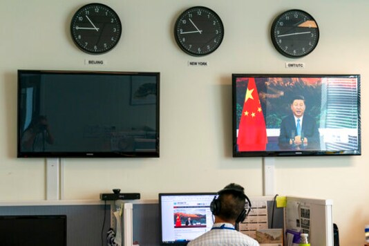 A reporter with the Xinhua Press Agency watches as President Xi Jinping is seen on a video screen remotely addressing the 75th session of the United Nations General Assembly, Tuesday, Sept. 22, 2020, at U.N. headquarters. This year's annual gathering of world leaders at U.N. headquarters will be almost entirely A reporter with the Xinhua Press Agency watches as President Xi Jinping is seen on a video screen remotely addressing the 75th session of the United Nations General Assembly, Tuesday, Sept. 22, 2020, at U.N. headquarters. This year's annual gathering of world leaders at U.N. headquarters will be almost entirely