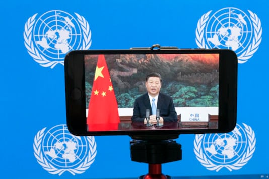 Chinese President Xi Jinping is seen on a phone screen remotely addressing the 75th session of the United Nations General Assembly, Tuesday, Sept. 22, 2020, at U.N. headquarters. This year's annual gathering of world leaders at U.N. headquarters will be almost entirely 