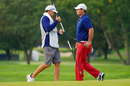 Patrick Reed, of the United States, hands his putter to his caddie during the first round of the US Open Golf Championship, Thursday, Sept. 17, 2020, in Mamaroneck, N.Y. (AP Photo/John Minchillo) Patrick Reed, of the United States, hands his putter to his caddie during the first round of the US Open Golf Championship, Thursday, Sept. 17, 2020, in Mamaroneck, N.Y. (AP Photo/John Minchillo)