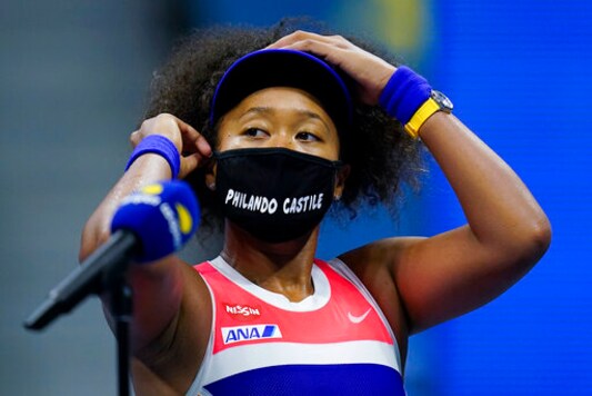 Naomi Osaka, of Japan, adjusts her mask after defeating Jennifer Brady, of the United States, during a semifinal match of the US Open tennis championships, Thursday, Sept. 10, 2020, in New York. (AP Photo/Seth Wenig)