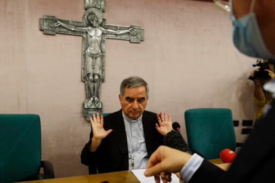 Cardinal Angelo Becciu talks to journalists during press conference in Rome, Friday, Sept. 25, 2020. The powerful head of the Vatican's saint-making office, Cardinal Angelo Becciu, has resigned from the post and renounced his rights as a cardinal amid a financial scandal that has reportedly implicated him indirectly. (AP Photo/Gregorio Borgia)