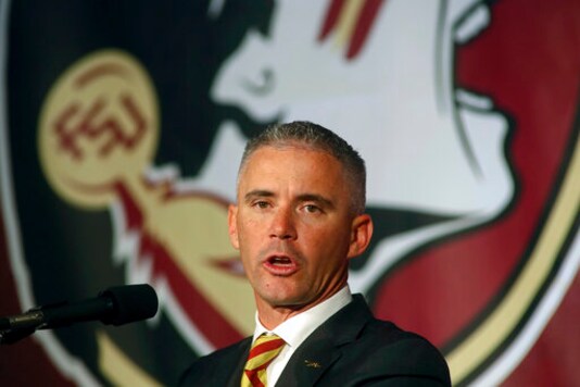 FILE - In this Dec. 8, 2019, file photo, Florida State head football coach Mike Norvell speaks at n during an NCAA college football press conference in Tallahassee, Fla. Norvell has tested positive for COVID-19 and will not coach the Seminoles in-person this week as they prepare for Miami. He released a statement Saturday, Sept. 19, 2020 saying he tested positive Friday. His wife and daughter tested negative Saturday morning, he said. (AP Photo/Phil Sears,  File)