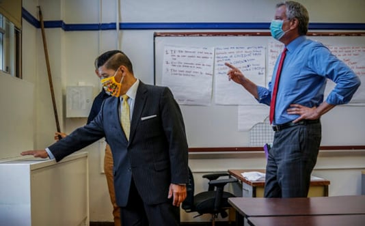 FILE - This photo from Wednesday, Aug. 26, 2020, file photo, School Chancellor Richard Carranza, left, and Mayor Bill de Blasio, are seen during an inspection of health safeguard protocols for COVID-19 at Bronx Collaborative High School in New York. After being delayed twice, hundreds of thousands of elementary school students are heading back to classrooms Tuesday, Sept. 29 with in-person learning for middle and high school students scheduled to begin Thursday. (AP Photo/Bebeto Matthews, File) FILE - This photo from Wednesday, Aug. 26, 2020, file photo, School Chancellor Richard Carranza, left, and Mayor Bill de Blasio, are seen during an inspection of health safeguard protocols for COVID-19 at Bronx Collaborative High School in New York. After being delayed twice, hundreds of thousands of elementary school students are heading back to classrooms Tuesday, Sept. 29 with in-person learning for middle and high school students scheduled to begin Thursday. (AP Photo/Bebeto Matthews, File)