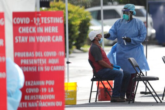 FILE - In this July 6, 2020 file photo, a health care worker administers a COVID-19 test at a site sponsored by Community Heath of South Florida at the Martin Luther King, Jr. Clinica Campesina Health Center in Homestead, Fla. A drug company says on Friday, Sept. 18, that a medicine it sells to tamp down inflammation has helped prevent the need for breathing machines in hospitalized COVID-19 patients in the first large study that primarily enrolled minorities. (AP Photo/Lynne Sladky, File) FILE - In this July 6, 2020 file photo, a health care worker administers a COVID-19 test at a site sponsored by Community Heath of South Florida at the Martin Luther King, Jr. Clinica Campesina Health Center in Homestead, Fla. A drug company says on Friday, Sept. 18, that a medicine it sells to tamp down inflammation has helped prevent the need for breathing machines in hospitalized COVID-19 patients in the first large study that primarily enrolled minorities. (AP Photo/Lynne Sladky, File)