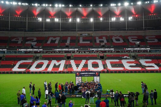 Soccer players of Flamengo celebrate with their trophy after winning the Rio de Janeiro state championship at the Maracana stadium, Rio de Janeiro, Brazil, Wednesday, July 15, 2020. The match was played without spectators to curb the spread of COVID-19.(AP Photo/Leo Correa)