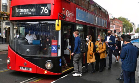 People board a bus outside Waterloo station in London, Wednesday, Sept. 23, 2020, after Prime Minister Boris Johnson announced a range of new restrictions to combat the rise in coronavirus cases in England, Wednesday, Sept. 23, 2020. (Dominic Lipinski/PA via AP)