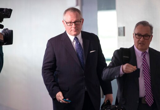 FILE - In this May 1, 2018, file photo, Former Donald Trump campaign official Michael Caputo, left, joined by his attorney Dennis C. Vacco, leaves after being interviewed by Senate Intelligence Committee staff investigating Russian meddling in the 2016 presidential election, on Capitol Hill in Washington. A House subcommittee examining President Donald Trumps response to the coronavirus pandemic is launching an investigation into reports that political appointees have meddled with routine government scientific data to better align with Trumps public statements. The Democrat-led subcommittee said Sept. 14, 2020 that it is requesting transcribed interviews with seven officials from the Centers for Disease Control and Prevention and the Department of Health and Human Services, including communications aide Michael Caputo. (AP Photo/J. Scott Applewhite, File)