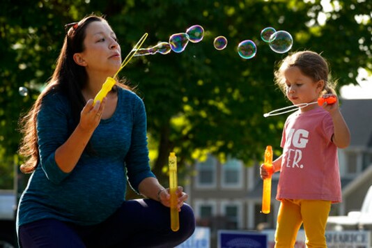 Claire Reagan plays with her daughter Abbie, 3, Monday, Sept. 21, 2020, outside her home in Olathe, Kan. Reagan is keeping her son Evan, age 5, from starting kindergarten and her daughter from preschool due to concerns about the coronavirus pandemic. (AP Photo/Charlie Riedel) Claire Reagan plays with her daughter Abbie, 3, Monday, Sept. 21, 2020, outside her home in Olathe, Kan. Reagan is keeping her son Evan, age 5, from starting kindergarten and her daughter from preschool due to concerns about the coronavirus pandemic. (AP Photo/Charlie Riedel)