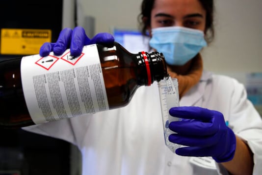 Seminar Kibir, health lab technician prepares chemicals to process analysis of some nasal swab samples to test for COVID-19 at the Hospital of Argenteuil, north of Paris, Friday Sept. 25, 2020. France's health agency announced Thursday evening that the country has had 52 new deaths and has detected over 16,000 new cases of coronavirus in 24 hours. (AP Photo/Francois Mori)