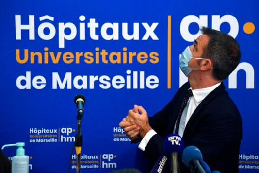 French Health Minister Olivier Veran holds a press conference at La Timone public hospital, Friday Sept. 25, 2020 in Marseille, southern France. Angry restaurant and bar owners demonstrated in Marseille to challenge a French government order to close all public venues as of Saturday to battle resurgent virus infections. The government argues that hospitals in this Mediterranean city are under strain and the closures are the only way to stem the spread while avoiding new lockdowns. (Christophe Simon, Pool via AP)