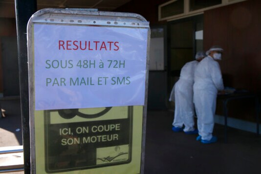 A technician wash their hands after collecting nasal swab samples for COVID-19 at a drive-through testing centre where results are expected with 2 or 3 days, in Wambrechies, northern France, Monday, Sept.21, 2020. Coronavirus infections tipped the scales again in France on Saturday with nearly 13,500 new infections in 24 hours. (AP Photo/Michel Spingler)