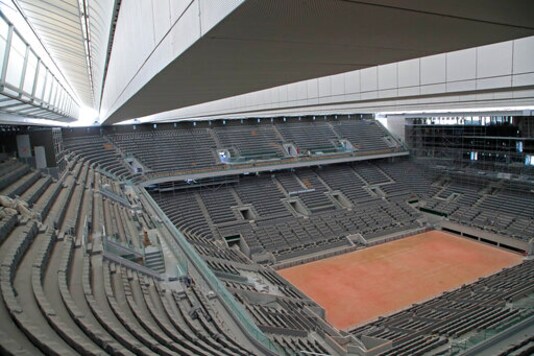 FILE - In this Wednesday, May 27, 2020 file photo, a general view of the Philippe-Chatrier tennis court with its new retractable roof during a media tour at Roland Garros stadium in Paris. Damir Dzumhur's coach called Roland Garros organizers 