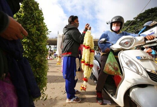A flower vendor wearing face mask as a precaution against coronavirus interacts with a prospective buyer at a wholesale market in Bengaluru, India, Thursday, Sept. 24, 2020. The nation of 1.3 billion people is expected to become the pandemic's worst-hit country within weeks, surpassing the United States. (AP Photo/Aijaz Rahi) A flower vendor wearing face mask as a precaution against coronavirus interacts with a prospective buyer at a wholesale market in Bengaluru, India, Thursday, Sept. 24, 2020. The nation of 1.3 billion people is expected to become the pandemic's worst-hit country within weeks, surpassing the United States. (AP Photo/Aijaz Rahi)
