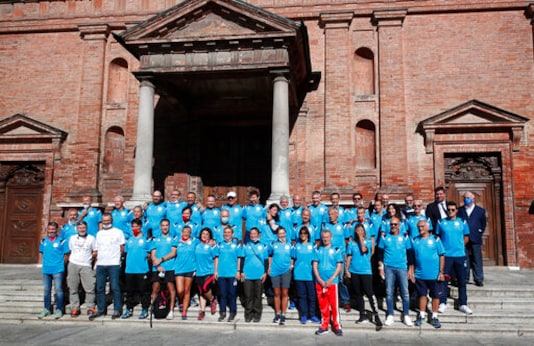 Runners pose prior to the start of a 180-kilometer relay race, in Codogno, Italy, Saturday, Sept. 26, 2020. Italys coronavirus Patient No. 1, whose case confirmed one of the worlds deadliest outbreaks was underway, is taking part in a 180-kilometer relay race as a sign of hope for COVID victims after he himself recovered from weeks in intensive care. Mattia Maestri, a 38-year-old Unilever manager, was suited up Saturday for the start of the two-day race between Italys first two virus hotspots. It began in Codogno, where Maestri tested positive Feb. 21, and was ending Sunday in VoEuganeo, where Italys first official COVID death was recorded the same day. (AP Photo/Antonio Calanni)