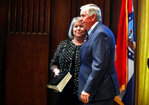FILE - In this June 1, 2018 file photo, Gov. Mike Parson, right, smiles along side his wife, Teresa, after being sworn in as Missouri's 57th governor in Jefferson City, Mo. Teresa Parson has tested positive for the coronavirus after experiencing mild symptoms, a spokeswoman for the governor said Wednesday, Sept. 23, 2020.  (AP Photo/Jeff Roberson, File)