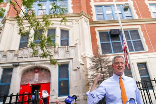FILE - In this Aug. 19, 2020, file photo, New York Mayor Bill de Blasio speaks to reporters after visiting New Bridges Elementary School to observe pandemic-related safety procedures, in the Brooklyn borough of New York. For most schoolchildren in New York City, Monday, Sept. 21, 2020, will mean back to school, but not back to the classroom. Only pre-kindergarteners and some special education students are scheduled to end a six-month absence from school buildings. (AP Photo/John Minchillo, FIle) FILE - In this Aug. 19, 2020, file photo, New York Mayor Bill de Blasio speaks to reporters after visiting New Bridges Elementary School to observe pandemic-related safety procedures, in the Brooklyn borough of New York. For most schoolchildren in New York City, Monday, Sept. 21, 2020, will mean back to school, but not back to the classroom. Only pre-kindergarteners and some special education students are scheduled to end a six-month absence from school buildings. (AP Photo/John Minchillo, FIle)