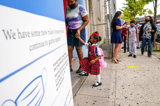 Students wear protective masks as they arrive for classes at the Immaculate Conception School while observing COVID-19 prevention protocols, Wednesday, Sept. 9, 2020, in the Bronx borough of New York. (AP Photo/John Minchillo) Students wear protective masks as they arrive for classes at the Immaculate Conception School while observing COVID-19 prevention protocols, Wednesday, Sept. 9, 2020, in the Bronx borough of New York. (AP Photo/John Minchillo)