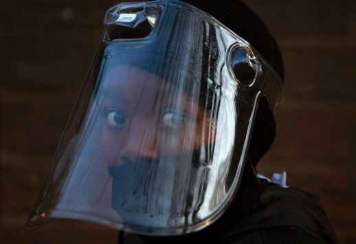 FILE - In this Aug. 24, 2020 file photo. a student, wearing a face mask and shield, returns to the Melpark Primary School in Johannesburg. The country's success in bringing its first wave of COVID-19 under control has allowed it to almost fully reopen the economy, while monitoring for signs of a second surge, says the government's chief medical advisor. (AP Photo/Denis Farrell, file) FILE - In this Aug. 24, 2020 file photo. a student, wearing a face mask and shield, returns to the Melpark Primary School in Johannesburg. The country's success in bringing its first wave of COVID-19 under control has allowed it to almost fully reopen the economy, while monitoring for signs of a second surge, says the government's chief medical advisor. (AP Photo/Denis Farrell, file)