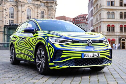 FILE - In this July 29, 2020 file photo, a VW ID.4 stands in front of the Frauenkirche on the occasion of a Volkswagen vehicle presentation on the Neumarkt in Dresden, Germany. Germany's Volkswagen is unveiling the ID.4, the battery-powered sport-utility vehicle that is headed for global markets including the United States and China, as the company takes a major step forward in its campaign to make electric cars a mass-market choice. (Sebastian Kahnert/dpa via AP, File) FILE - In this July 29, 2020 file photo, a VW ID.4 stands in front of the Frauenkirche on the occasion of a Volkswagen vehicle presentation on the Neumarkt in Dresden, Germany. Germany's Volkswagen is unveiling the ID.4, the battery-powered sport-utility vehicle that is headed for global markets including the United States and China, as the company takes a major step forward in its campaign to make electric cars a mass-market choice. (Sebastian Kahnert/dpa via AP, File)