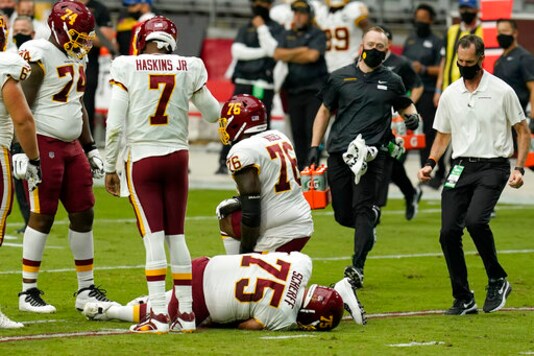 Washington Football Team offensive guard Brandon Scherff (75) lies on the turf after an injury against the Arizona Cardinals during the first half of an NFL football game, Sunday, Sept. 20, 2020, in Glendale, Ariz. Washington will be without its best offensive lineman for at least a couple of weeks after guard Brandon Scherff injured his right knee and missed the second half of a 30-15 loss at Arizona. AP Photo/Ross D. Franklin)