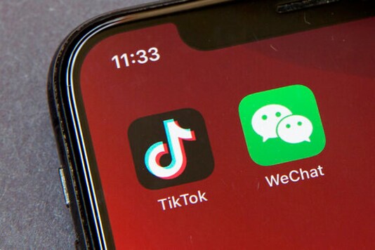 FILE - Icons for the smartphone apps TikTok and WeChat are seen on a smartphone screen in Beijing, in a Friday, Aug. 7, 2020 file photo.  The Commerce Department said President Trumps proposed ban of the apps WeChat and TikTok will go into effect Sunday, Sept. 20,  to safeguard the national security of the United States. The government said its order, previously announced by Trump in August, will combat Chinas malicious collection of American citizens personal data.  (AP Photo/Mark Schiefelbein, File)