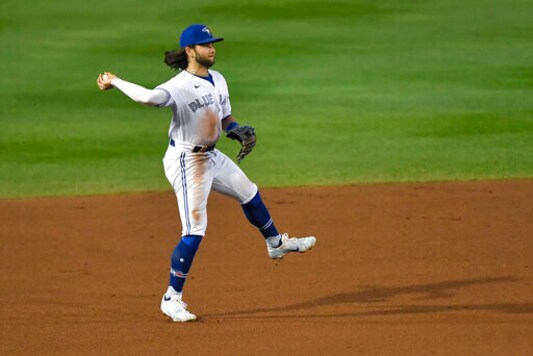 Toronto Blue Jays shortstop Bo Bichette fields a ground ball by New York Yankees' Gio Urshela who was out at first during the fourth inning of a baseball game in Buffalo, N.Y., Monday, Sept. 21, 2020. (AP Photo/Adrian Kraus)