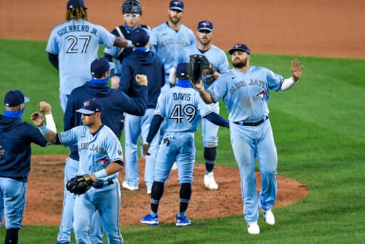Toronto Blue Jays first baseman Rowdy Tellez, right, celebrates a win over the New York Yankees with teammates after a baseball game in Buffalo, N.Y., Monday, Sept. 7, 2020. (AP Photo/Adrian Kraus) Toronto Blue Jays first baseman Rowdy Tellez, right, celebrates a win over the New York Yankees with teammates after a baseball game in Buffalo, N.Y., Monday, Sept. 7, 2020. (AP Photo/Adrian Kraus)