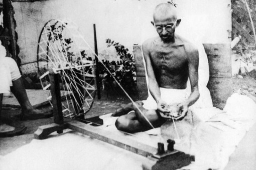 Mahatma Gandhi spinning Khadi in his wheel