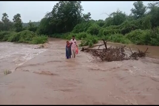 The volunteer crossing the river stream.
