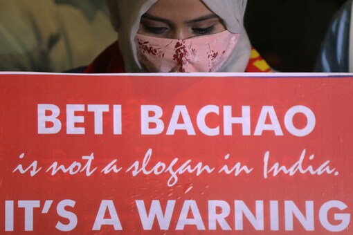 Representative Image: A woman holds a placard during a protest after the death of a rape victim, in Mumbai. (REUTERS)