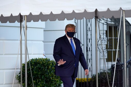 President Donald Trump waves to members of the media as he leaves the White House to go to Walter Reed National Military Medical Center after he tested positive for COVID-19 in Washington. (AP Photo)