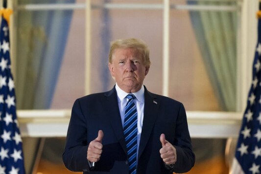 President Donald Trump gives thumbs up as he stands on the Blue Room Balcony upon returning to the White House Monday, Oct. 5, 2020, in Washington, after leaving Walter Reed National Military Medical Center, in Bethesda, Md. Trump announced he tested positive for COVID-19 on Oct. 2. (AP Photo/Alex Brandon) President Donald Trump gives thumbs up as he stands on the Blue Room Balcony upon returning to the White House Monday, Oct. 5, 2020, in Washington, after leaving Walter Reed National Military Medical Center, in Bethesda, Md. Trump announced he tested positive for COVID-19 on Oct. 2. (AP Photo/Alex Brandon)
