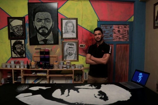 Artist in front of the image of Al Pacino.
(Credit: Reuters)