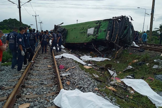 Rescuers stand by a damaged train and bodies covered with white sheets after a bus-train collision in Chacheongsao province, 80 kilometers (50 miles) east of Bangkok, Thailand, Sunday, Oct. 11, 2020. (Daily News Via AP) Rescuers stand by a damaged train and bodies covered with white sheets after a bus-train collision in Chacheongsao province, 80 kilometers (50 miles) east of Bangkok, Thailand, Sunday, Oct. 11, 2020. (Daily News Via AP)