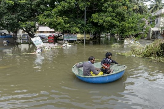 Workers use a boat to evacuate residents on a flooded street in Hyderabad on Thursday. (AFP) Workers use a boat to evacuate residents on a flooded street in Hyderabad on Thursday. (AFP)