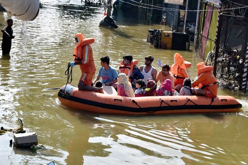 NDRF personnel carry out a rescue operation to move locals to a safer place following heavy rain, at Al-Jubail Colony in Hyderabad, Thursday, Oct. 15, 2020. (PTI Photo)