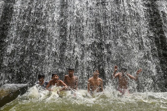 Children play near an overflowing Powai lake following heavy rains, in Mumbai, Thursday, Oct. 15, 2020. (Image: PTI) Children play near an overflowing Powai lake following heavy rains, in Mumbai, Thursday, Oct. 15, 2020. (Image: PTI)