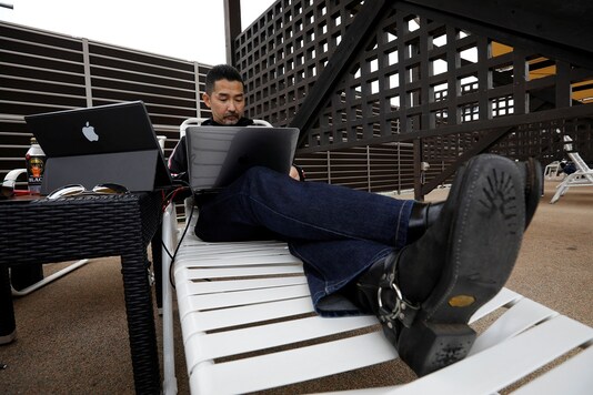 Fleq's president Tatsuki Yamamoto works on a pool deck chair at 'Amusement Workation' at Yomiuriland in Tokyo. (REUTERS/Kim Kyung-Hoon) Fleq's president Tatsuki Yamamoto works on a pool deck chair at 'Amusement Workation' at Yomiuriland in Tokyo. (REUTERS/Kim Kyung-Hoon)
