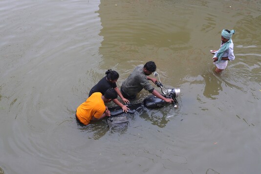 People wade through floodwaters after heavy rainfall in Hyderabad, India, India, Wednesday, Oct. 14, 2020. (AP Photo/Mahesh Kumar A.)
People wade through floodwaters after heavy rainfall in Hyderabad, India, India, Wednesday, Oct. 14, 2020. (AP Photo/Mahesh Kumar A.)