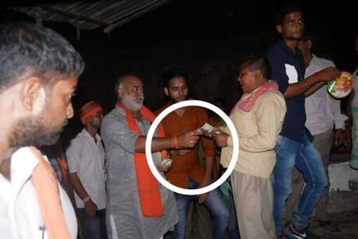 BJP candidate from Jaunpur’s Malhani constituency was allegedly caught distributing money in a viral picuture.