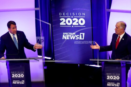 Democratic challenger Cal Cunningham, left, and U.S. Sen. Thom Tillis, R-N.C., talk during a televised debate Thursday, Oct. 1, 2020, in Raleigh, N.C. (AP Photo/Gerry Broome, Pool)