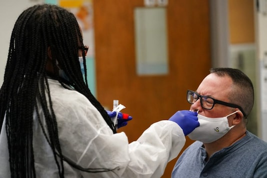 Instructor submits a COVID-19 nasal swab test at West Brooklyn Community High School, Thursday, Oct. 29, 2020, in New York. Instructor submits a COVID-19 nasal swab test at West Brooklyn Community High School, Thursday, Oct. 29, 2020, in New York.