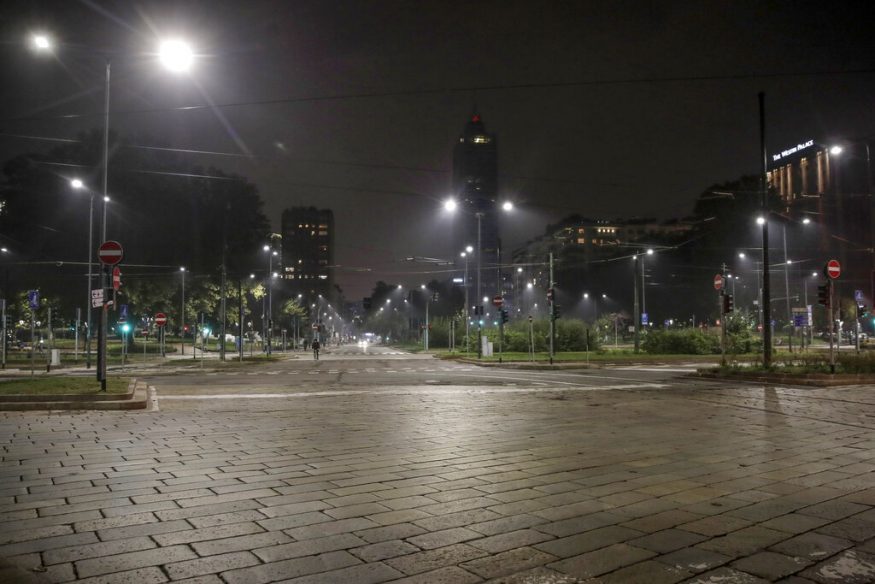  An empty street is lit by street lights in Milan, Italy. (Image: AP)